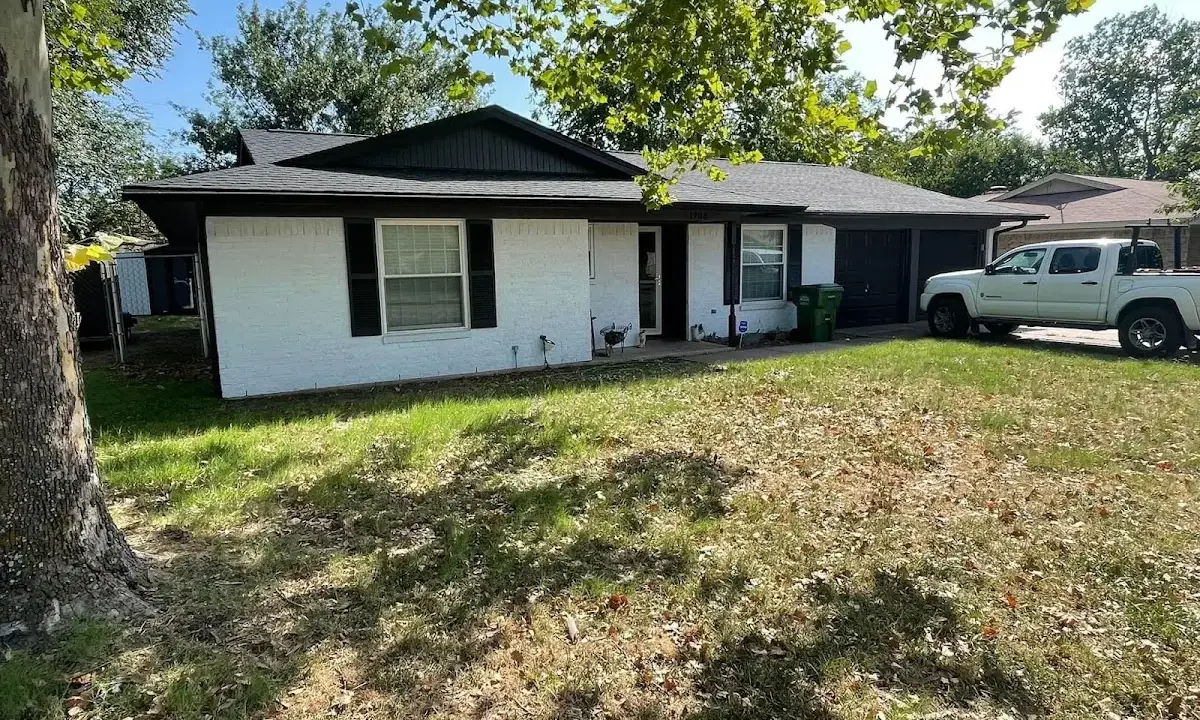 Professional roofing crew working on a residential roof in Fraser